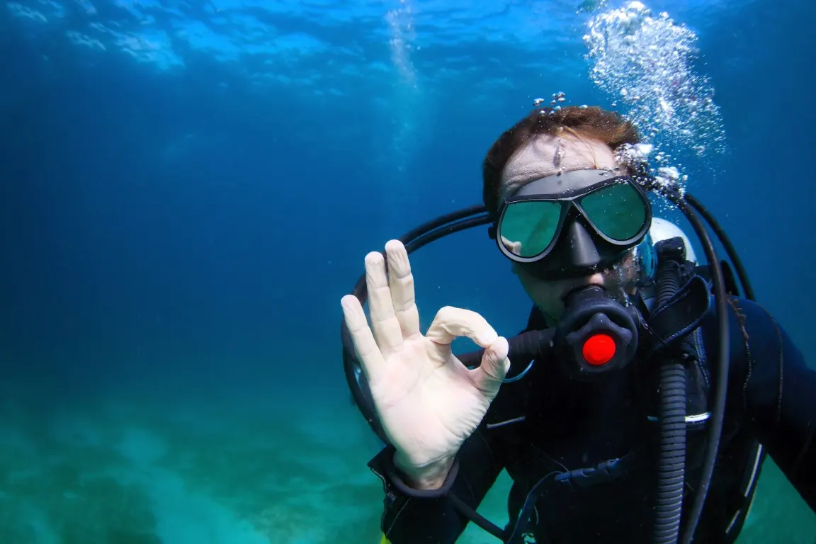 Diver giving the OK sign in shallow water off Pag